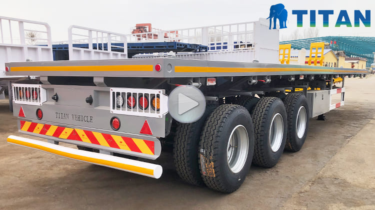 Video of Flatbed Semi Truck Trailer  Tri Axle Semi Flatbed Trailers for Sale Price: 10000 USD The 3 axle flatbed semi trailer for sale are road transport designed for transporting standard containers, and are commonly found in ports, logistics and other places. The flat bed semi trailer for sale are widely used in modern logistics and transportation because of the ability to adapt to a variety of transportation modes, convenient loading and unloading, and low cost. In addition, the 40 ft flatbed semi trailer can also be used to transport bulk cargoes to meet the different types of transportation needs.   Specification of Flatbed Trailer 3 Axle Overall Dimension: 12500mm*2500mm*1590mm Load Capacity: 60 ton Floor Plate: 3mm thick pattern floor plate Side Beam: 160mm high Bumper: 4mm thick Axles: 3 axles, 13ton Tire: 12 units, 12R22.5 Landing Gear: 28 ton Suspension: mechanical suspension Leaf Spring: 10 layers Lamp: LED Lamp with anti-theft design  Advantage of 3 Axle Flatbed Semi Trailer The type of semi truck flatbed trailer for sale adopts an open floor design, which greatly facilitates the loading and unloading operations of goods. The structural form improves loading and unloading efficiency and also enhances the diversity of transportation methods.  For Nigeria customers, the semi truck and flatbed trailer for sale design brings more flexible choices. The 40 ft flatbed semi trailer patterned plate material used for the floor is not only beautiful in appearance, but also has good anti-slip properties.  Regarding tire configuration, the semi truck and flatbed trailer for sale is equipped with 12R22.5 tires as standard. TITAN deeply considers market feedback and Nigeria customer needs , and through rigorous test and verification, ensures great stability and durability of the semi flatbed trailers for sale during actual operation. The semi flatbed trailers for sale adopt high-strength alloy steel in floor plate that can withstand large loads and has a certain degree of corrosion resistance. The advantages of the material are particularly prominent in the wet rainy season, which can effectively prevent the tri axle flatbed semi trailer body from rusting, thereby ensuring the safety and durability of the flatbed semi truck trailer during a long time to use. The design of the rope tightener plays an important role in the transportation process as well. The device are distributed on both sides of the 40 ft flatbed semi trailer and can effectively fix the bulk cargo when the 3 axle flatbed semi trailer for sale brakes in an emergency to prevent from sliding or moving.  In terms of structure, the 3 axle flatbed semi trailer for sale cross beam is made of 100mm thickened channel steel. The thickened cross beam enhances the strength of the overall structure, allowing the flat bed semi trailer for sale to maintain a stable shape and not easily deformed when fully loaded.  To further enhance the flatbed trailer 3 axle structural firmness, diagonal braces are added between the cross beams, and the triangular structure principle is used to firmly connect to the main beam. The spacing between the diagonal braces is controlled within 500mm to ensure uniform force distribution. The structural can effectively prevent deformation of the 40 ft flatbed semi trailer body when transporting heavy bulk cargoes. The device has a simple structure, convenient operation, and is easy for Nigeria users to master, which help improve the efficiency and safety of transportation operations. The open loading area of the tri axle flatbed semi trailer is particularly practical when facing large scale cargo transportation. The flatbed trailer 3 axle can accommodate 20 foot or 40 foot containers, taking into account loading efficiency and adaptability to standard containers. There are 12 container locks on the semi truck flatbed trailer for sale floor plate, and the lock positions are not completely equidistant.   Shipping of Flatbed Semi Truck Trailer To protect the 3 axle flatbed semi trailer for sale from rust during transportation, TITAN implements waterproofing measures that are not typically offered by other manufacturers. Before shipment, TITAN applies a layer of wax and covers all flat bed semi trailer for sale with waterproof raincoats which helps safeguard the trailers from corrosion caused by seawater and sea breeze during ocean transport.